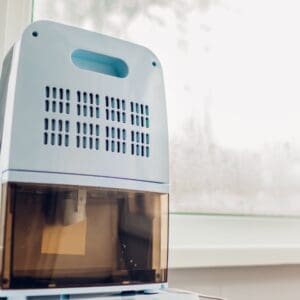 A small white air conditioner sitting on top of a table.